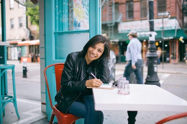 woman sitting at table in downtown location