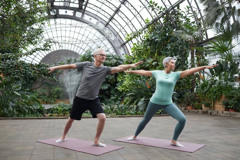 Senior man and woman do yoga at their Active Adult Community.